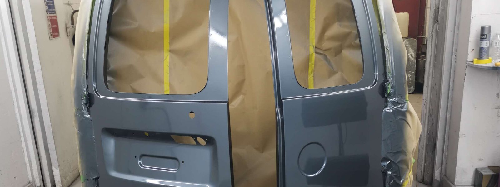 A van's rear doors masked up and freshly resprayed in the Car Repair Business booth
